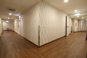 an empty hallway with white walls and wooden floors at Tomorrow Hotel in Taipei