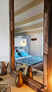 a mirror reflection of a bed in a bedroom at Laubertière in Marennes +50 photos
