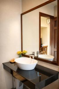 a bathroom with a sink and a large mirror at Soleil House in Hue +23 photos