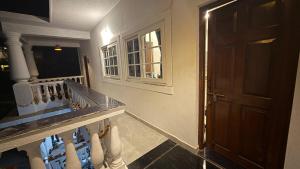 a room with a staircase with a door and a staircase at Riverside By GikiJoy in Agarvado