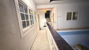 a hallway of a house with windows and a counter at Riverside By GikiJoy in Agarvado +5 photos