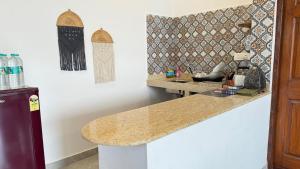 a kitchen with a counter top and a wall at Riverside By GikiJoy in Agarvado