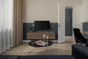 a living room with a couch and a tv at Oikia Classic House in Old Town Kavala in Kavála