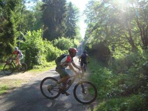 a group of people riding bikes down a dirt road at Gîte Nid dans la Forêt in Saint-Jean-aux-Bois +23 photos