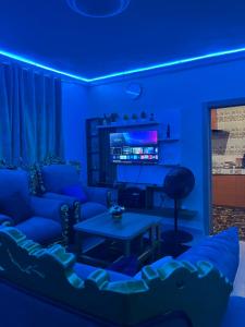 a blue room with a couch and a table at RYN Apartment Ayobo-Ishefun, Lagos Flat1 in Itele