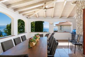 a dining room with a long table and chairs at Villa The Nest in Opatija