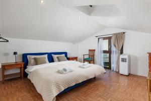 a bedroom with a bed with towels on it at Villa The Nest in Opatija