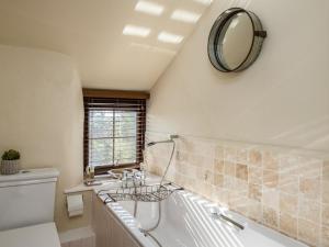a bathroom with a tub and a mirror on the wall at Trehaverock Cottage in Port Isaac +21 photos