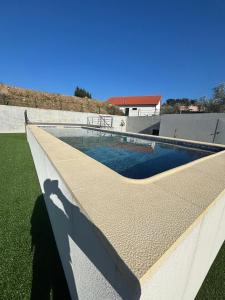 a swimming pool on the side of a house at T1 Luxgarden in Lamego