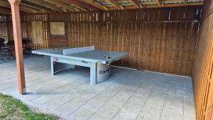 a ping pong table sitting on a patio at Malownicza Dolina in Wapnica