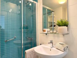 a bathroom with a sink and a glass shower at Hortensia Suites Apartments, Los Cristianos, Tenerife in Los Cristianos +156 photos