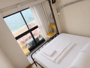 a room with a bed and a view of the ocean at Noahs Ark Beach in Nathon Bay +10 photos