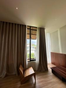 a living room with a couch and a window at Soleil House in Hue
