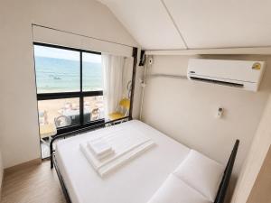 a room with a bed with a view of the ocean at Noahs Ark Beach in Nathon Bay