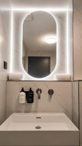 a bathroom with a sink and a mirror at Hotel am Augustinerplatz in Cologne +34 photos