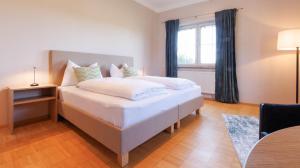 a bedroom with a large white bed with a window at Apartment Gabriel in Melk