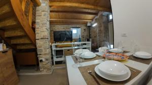 a kitchen with a table with white plates on it at Casa ArTè in Modica