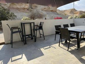 a table and chairs sitting on a patio at אצל מאיה ואבשי Maya and Avshi in Neʼot HaKikar +35 photos