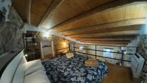 a bedroom with a bed and a wooden ceiling at Casa ArTè in Modica