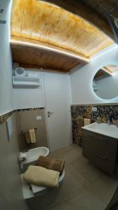 a small bathroom with a toilet and a sink at Casa ArTè in Modica +27 photos