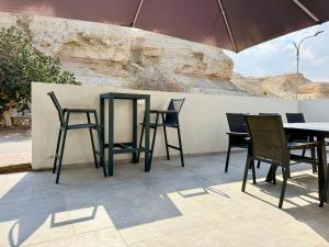 a group of chairs and tables on a patio at אצל מאיה ואבשי Maya and Avshi in Neʼot HaKikar