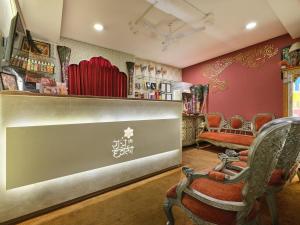 a barber shop with red walls and chairs at Radhey Ki Haveli in Khātu
