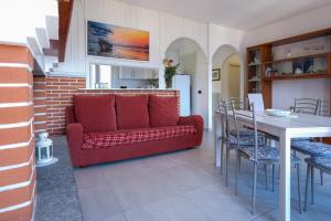 a living room with a red couch and a table at Villa Bianca in Perledo