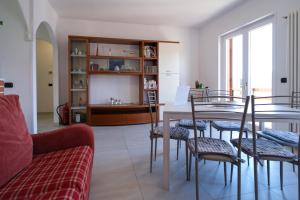 a living room with a table and chairs at Villa Bianca in Perledo +53 photos