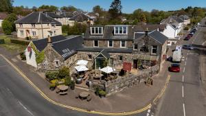 an aerial view of a building with tables and umbrellas at The Mill House in Stewarton
