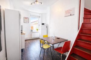 a small kitchen and dining room with a table and chairs at La Maison Créative in La Madeleine +12 photos