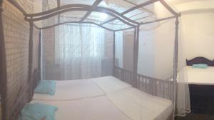 a bedroom with a canopy bed in a room at Hikka Urban Stay in Hikkaduwa