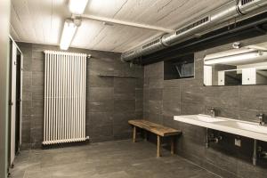 a bathroom with a bench and a sink and a radiator at Monteurhaus in Hausham