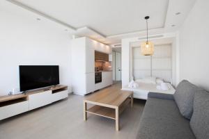 a living room with a couch and a tv at Casa Pedro Santa Clara in Torremolinos