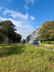 a grassy field next to a large building at el AS del Puntal in Villaviciosa