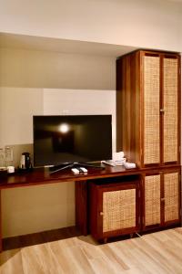 a room with a desk with a tv and a tvictericter at Soleil House in Hue