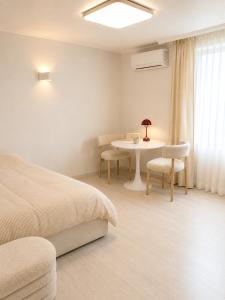 a bedroom with a bed and a table and chairs at Coco Villa Sinsa in Seoul