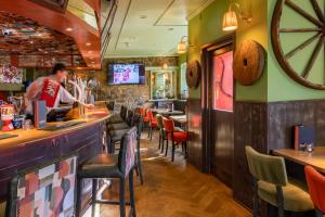 a man standing at a bar in a restaurant at The Mill House in Stewarton