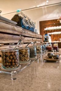 a counter with a bunch of different types of food at Parkhotel Steimker Berg Wolfsburg in Wolfsburg