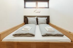 a bed in a room with two pillows on it at Harzchalet Emma 4 Sankt Andreasberg in Sankt Andreasberg