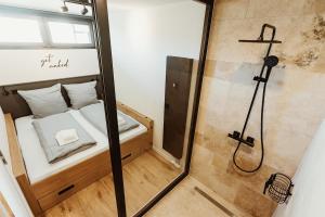 a small bathroom with a shower and a bed at Harzchalet Emma 4 Sankt Andreasberg in Sankt Andreasberg +48 photos