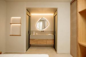 a bathroom with a sink and a mirror at MINT Keramoti in Keramoti