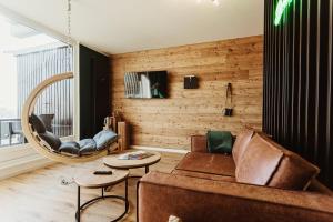 a living room with a couch and a table at Harzchalet Emma 4 Sankt Andreasberg in Sankt Andreasberg