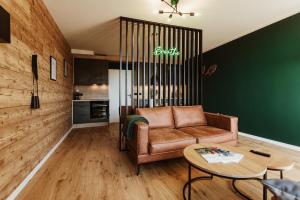 a living room with a couch and a table at Harzchalet Emma 4 Sankt Andreasberg in Sankt Andreasberg