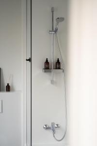 a shower with a shower head in a bathroom at A Place Antwerp - Boutique Hotel Emile in Antwerp +133 photos