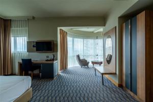 a hotel room with a bed and a desk at City Live Hotel in Antalya