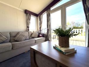 a living room with a couch and a table at Primrose View in Filey