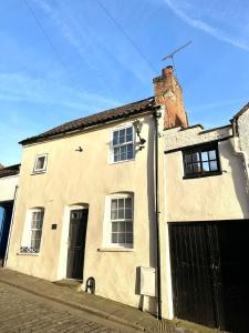a large white building with a door and windows at The Nook Lincoln in Lincolnshire