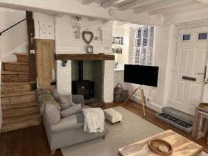 a living room with a couch and a fireplace at The Nook Lincoln in Lincolnshire +35 photos