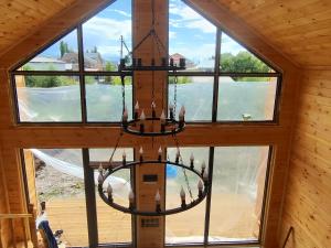 a chandelier hanging from the ceiling of a house at Zhyrgallaif in Darkan +1 photo