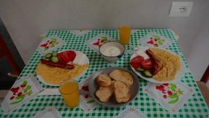 a green and white table with plates of food on it at Olive garden private Suite in Ksamil
